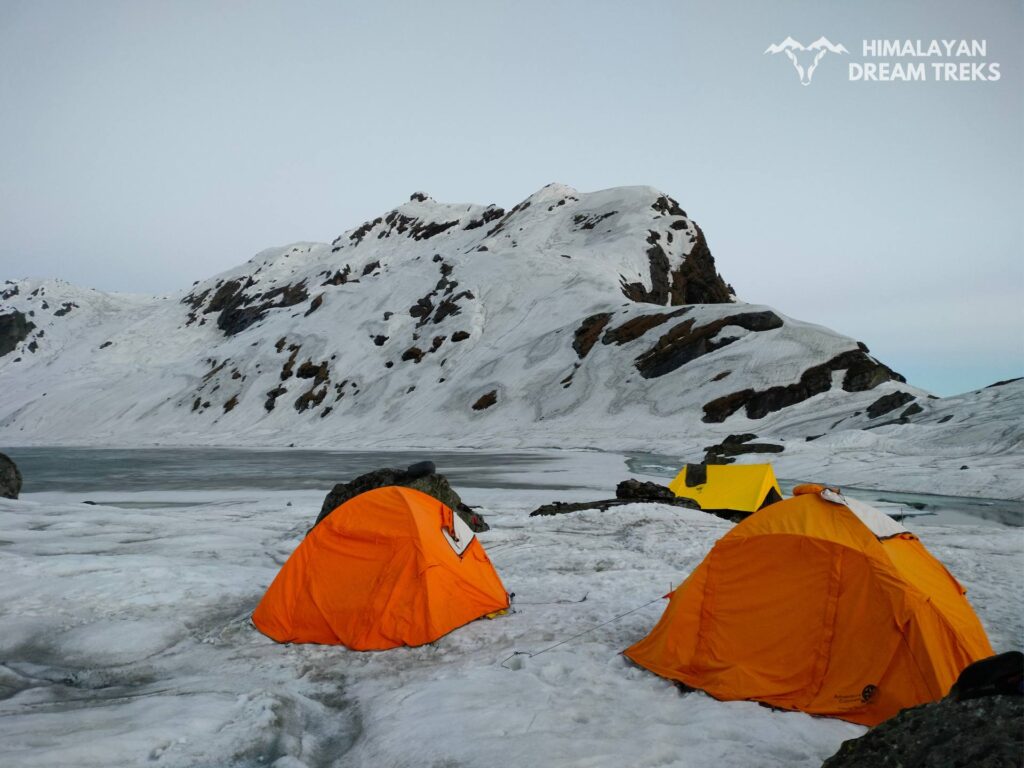 Tent set up at Auden Col base camp surrounded by snow-covered terrain