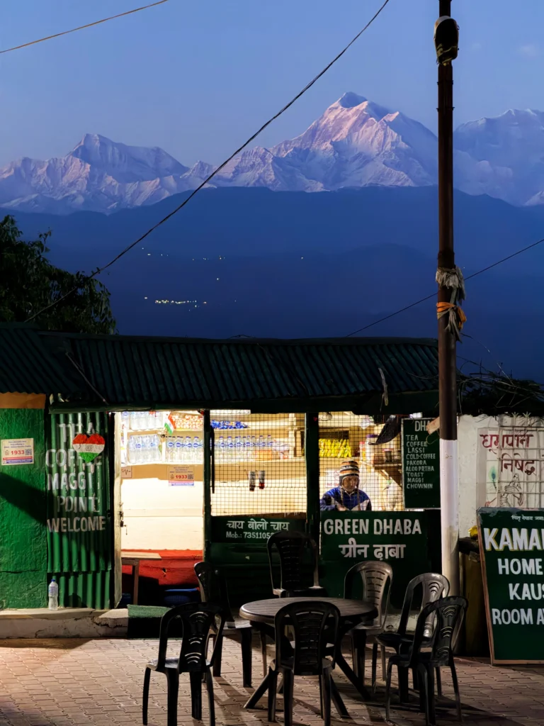 Evening view of a tea stall in Kausani with Trishul Peak glowing in the background