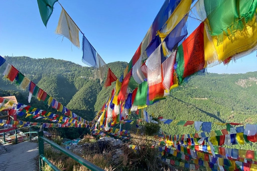 Prayer flags fluttering at Dalai Hills with panoramic Himalayan views near Mussoorie, Uttarakhand