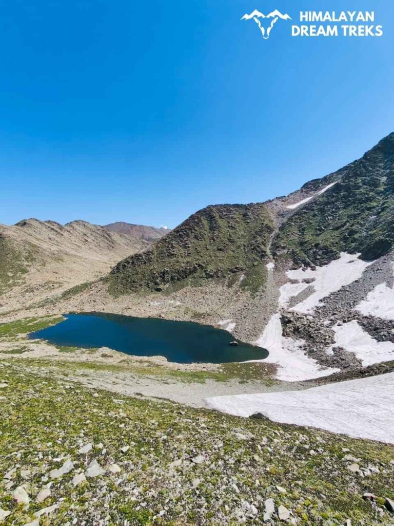 This lake is Kaldachni Sar, that we encounter on the 5th day of the Pir Panjal Lakes trek in Kashmir