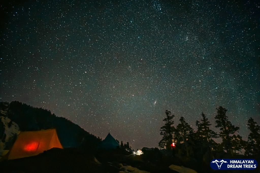 Stargazing experience at Kuari Pass with tents and mountains under the night sky