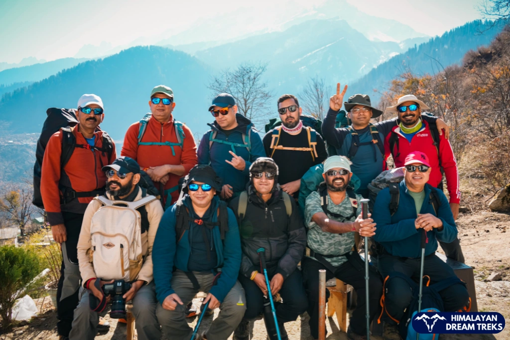 Group of trekkers posing with backpacks in Kuari Pass Trek