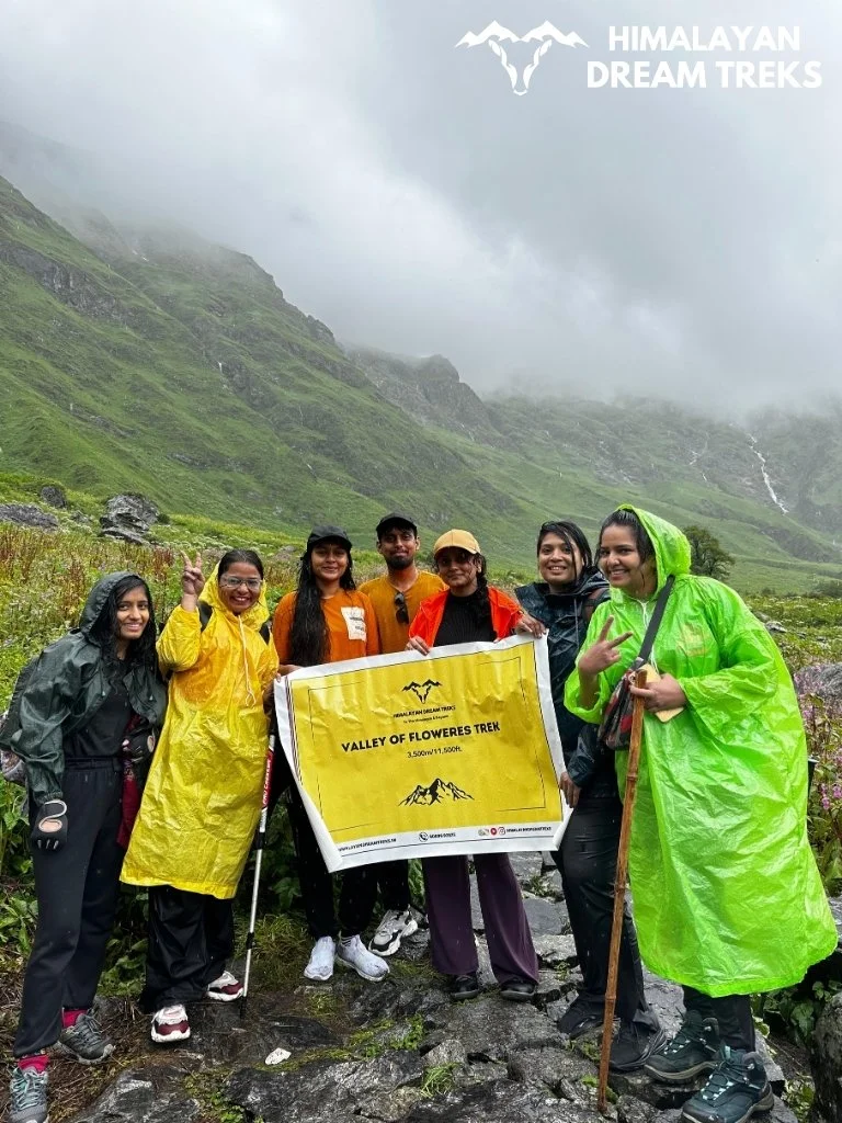 Team photo with the trekking banner amidst the blooming Valley of Flowers, Uttarakhand
