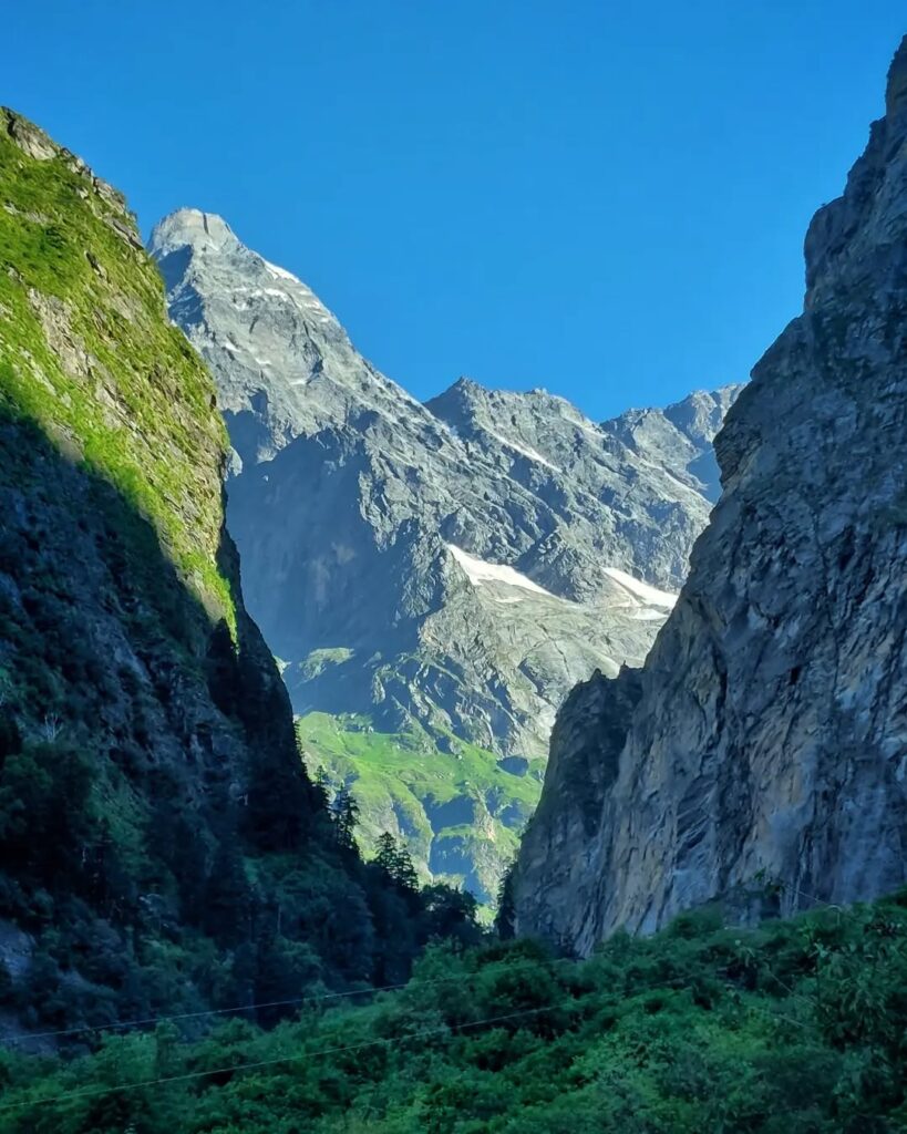 A breathtaking mountain under a clear blue sky, with every peak sharply visible in the crisp daylight