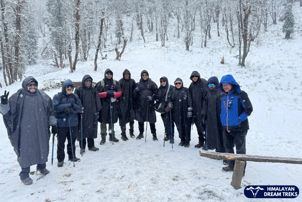 Kedarkantha trekkers posing together in fresh snow