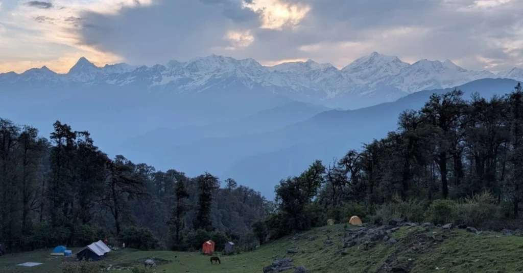 Peaceful green meadow at Dayara Bugyal with mountain views